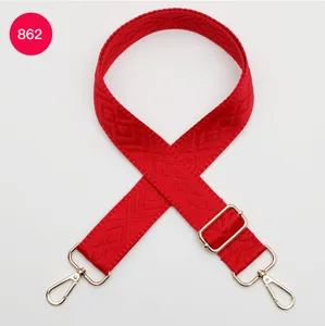 Tracolla di ricambio tessuta rossa con motivo a rombi geometrici e ganci dorati regolabili.