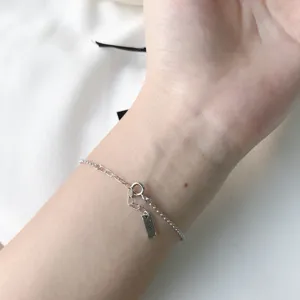 Nahaufnahme Detailaufnahme einer zarten Sterlingsilber Kette Armband am Handgelenk getragen.