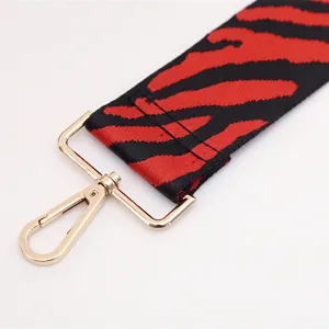 Wide replacement shoulder strap for women bags, red and black patterned design with gold hardware.