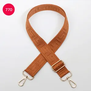 Adjustable woven replacement strap for bags in brown geometric pattern with gold hardware.