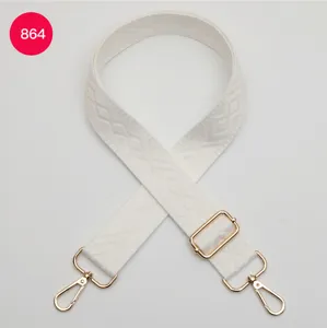 Tracolla di ricambio in tessuto bianco con fibbie e moschettoni in metallo dorato.
