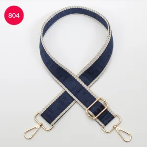 Adjustable wide replacement bag strap with blue labyrinth pattern and gold hardware.