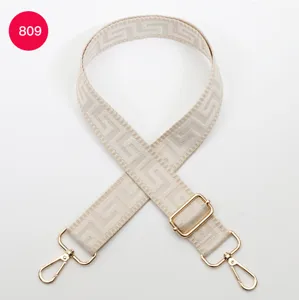 Adjustable wide replacement bag strap with chic geometric woven pattern and gold tone hardware.