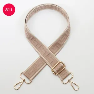 Adjustable wide bag strap replacement, beige woven geometric pattern with gold hardware.