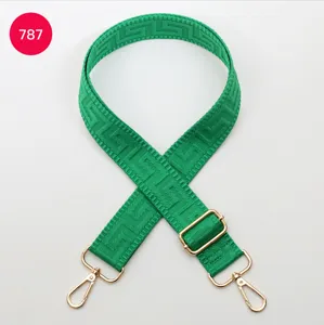 Green adjustable replacement bag strap featuring Greek key pattern and gold hardware.