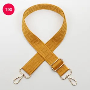 Adjustable yellow woven bag strap with metal hardware for shoulder crossbody bags.