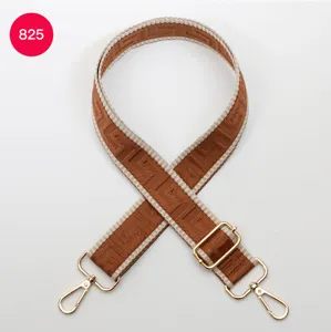Adjustable wide replacement bag strap featuring brown maze pattern and gold hardware.