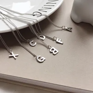 S925 sterling silver alphabet letter necklace detail shot, elegant silver chain pendant jewelry.