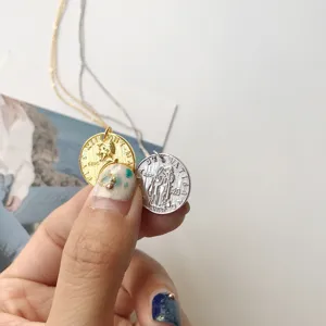 Detailed view of the S925 silver vintage coin pendant necklace with dual gold silver finish.