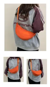 Lightweight nylon crescent crossbody bag in vibrant orange, stylish casual dumpling shoulder bag.