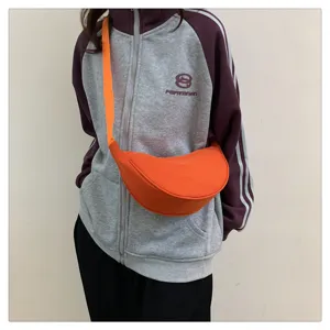 Orange nylon crescent crossbody bag for women, lightweight casual dumpling shoulder bag.