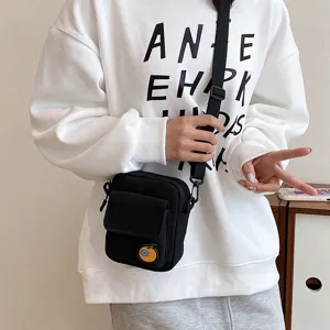 Cute black canvas crossbody bag for daily use, small phone shoulder bag with cute orange badge.