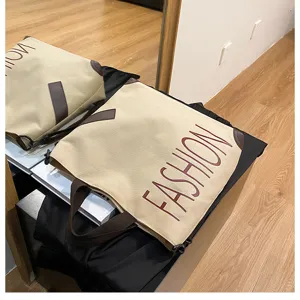 Large capacity canvas tote bag for women, stylish casual shoulder bag with durable dual handles.