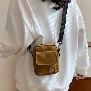 Cute canvas crossbody bag for women and teens, small daily shoulder bag with orange patch.