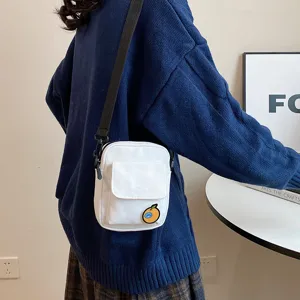 Cute canvas cross-body phone bag for girls, featuring a sweet fruit patch design and durable strap.