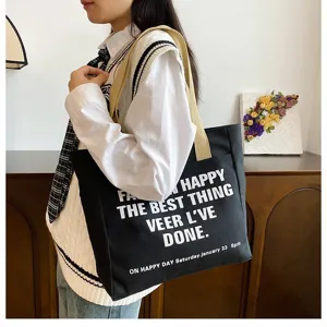 Black canvas tote bag for women large capacity casual shoulder bag daily commuter handbag.