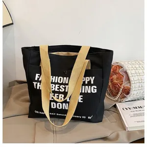 Black canvas tote bag detail, large capacity casual commuter shoulder bag with printed letters.