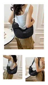 Detail view of stylish black patterned crescent shoulder bag featuring a mini pouch.