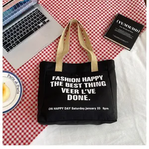 Black canvas tote bag large capacity casual shoulder bag for women daily commuting and school use.