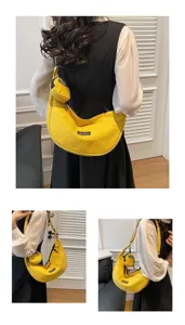 Stylish yellow crescent crossbody bag featuring small pouch, casual shoulder bag.