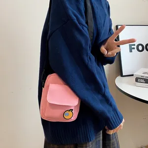 Cute pink canvas crossbody bag for girls, casual Japanese style phone pouch with orange patch.