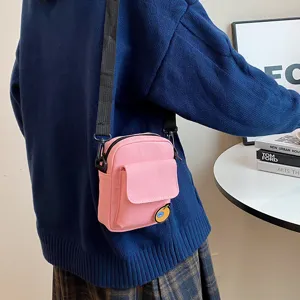 Cute pink canvas crossbody bag for girls, daily casual small phone shoulder bag with flap pocket.