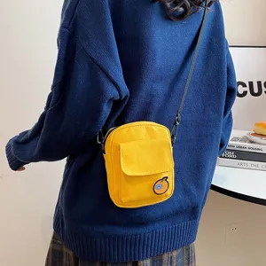 Cute yellow canvas crossbody bag for girls, sweet student shoulder bag with front pocket.