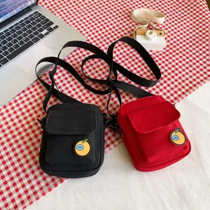 Cute Japanese style canvas crossbody bag for kids and girls with cute orange badge, red and black.