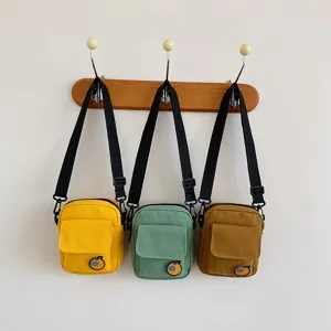 Cute canvas crossbody bag detail shot, displaying front pocket and cute patch design clearly.
