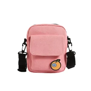 Cute pink canvas shoulder bag for kids, stylish crossbody phone bag with sweet cartoon badge.