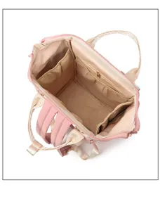 Detail view of the spacious pink diaper backpack interior with multiple organization pockets.
