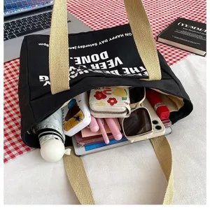 Black canvas tote bag with beige straps large capacity casual commuting handbag for daily use
