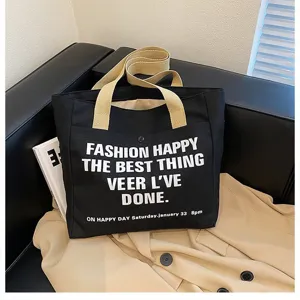 Detailed view of large capacity black canvas tote bag with beige straps for daily commuting.