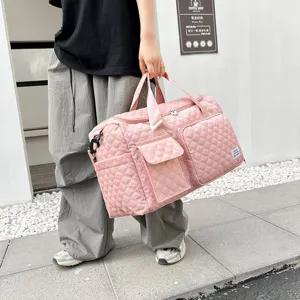 Stylish pink quilted travel duffel bag with large capacity, multiple pockets and durable straps.