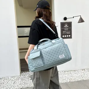 Light blue quilted travel duffel bag large capacity gym bag with shoe compartment.
