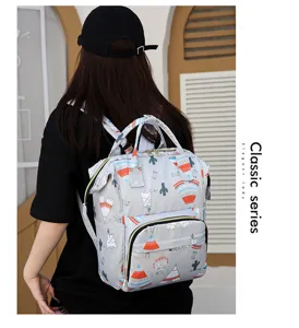 Detail view of grey cartoon print multi-functional mummy backpack with large capacity and straps.
