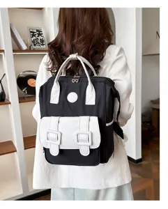Detail view of stylish black and white backpack in a modern indoor lifestyle scene display.