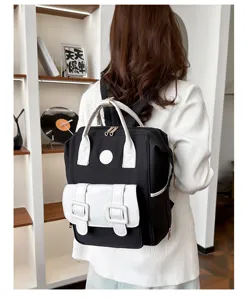Stylish black and white large capacity backpack diaper bag for mothers outdoor daily use.