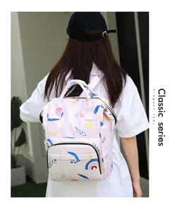 Multifunctional large capacity pink diaper backpack for mothers and babies, stylish and durable.