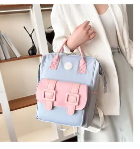 Detailed view of fashionable blue pink backpack with multiple pockets and shoulder straps.
