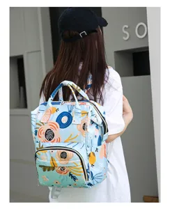 Multipurpose diaper backpack detail view showing large capacity and floral pattern design.