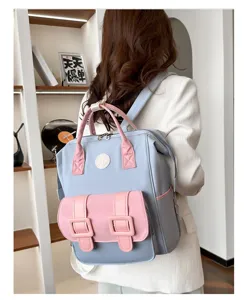 Multifunctional stylish diaper backpack in blue and pink, spacious storage for moms.
