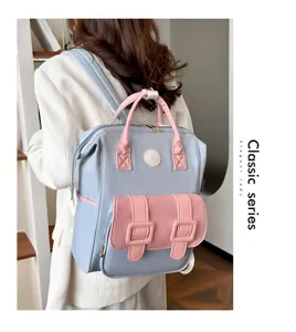 Multi-functional mommy backpack with large capacity, stylish pink and blue travel bag for moms.