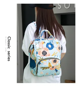 Detail view of the floral print diaper backpack, showing multi-pocket design and strap.