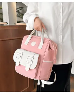Detailed view of the pink and white multi-functional mommy backpack with large capacity.