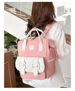 Detailed closeup view of the pink and white dual-handle backpack, showcasing quality stitching.