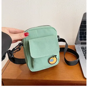 Small green canvas crossbody bag for women, cute orange badge casual shoulder bag.