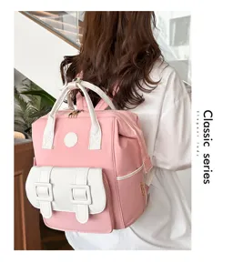 Detail view of the pink and white multi-functional mommy backpack with large storage space.