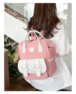 Detailed back view of a stylish pink and white multi-functional travel diaper backpack.