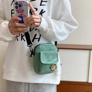 Small green canvas crossbody bag for women, cute casual shoulder bag with front pocket.